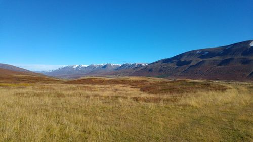 Scenic view of mountains against clear blue sky