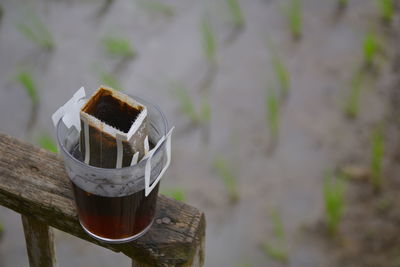 High angle view of cigarette on wooden post