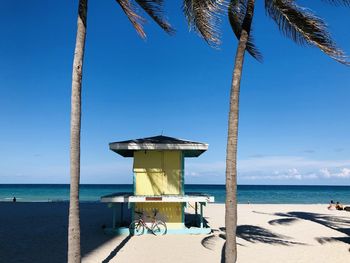 Lifeguard hut on beach against sky