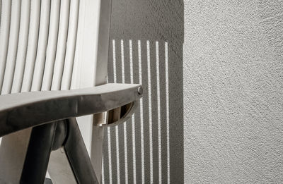 Close-up of chair against wall