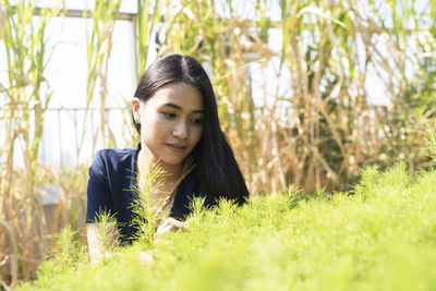 Portrait of beautiful young woman in field