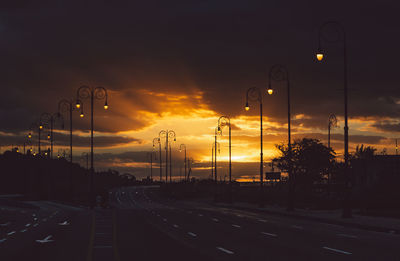 Street against sky during sunset