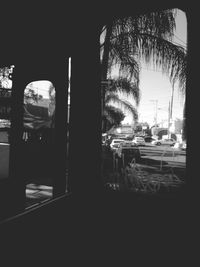 Cars on street seen through glass window