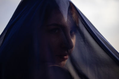 Close-up of woman covered with navy blue textile