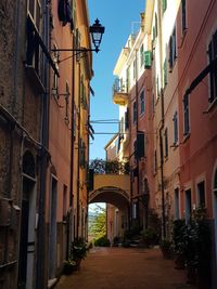 Low angle view of narrow alley amidst buildings in city