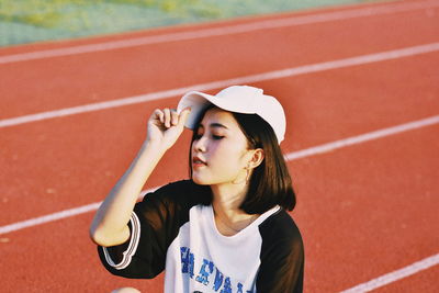 Young woman relaxing on running track