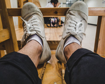 Low section of man sitting on wooden floor