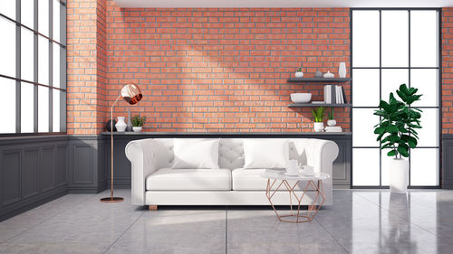 Modern loft interior design ,white sofa on brick wall and concrete floor