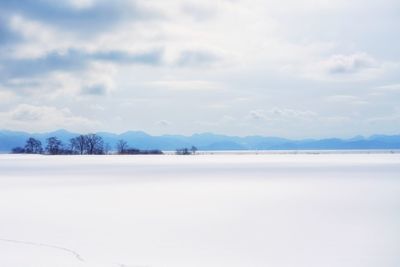 Scenic view of snow covered landscape against sky