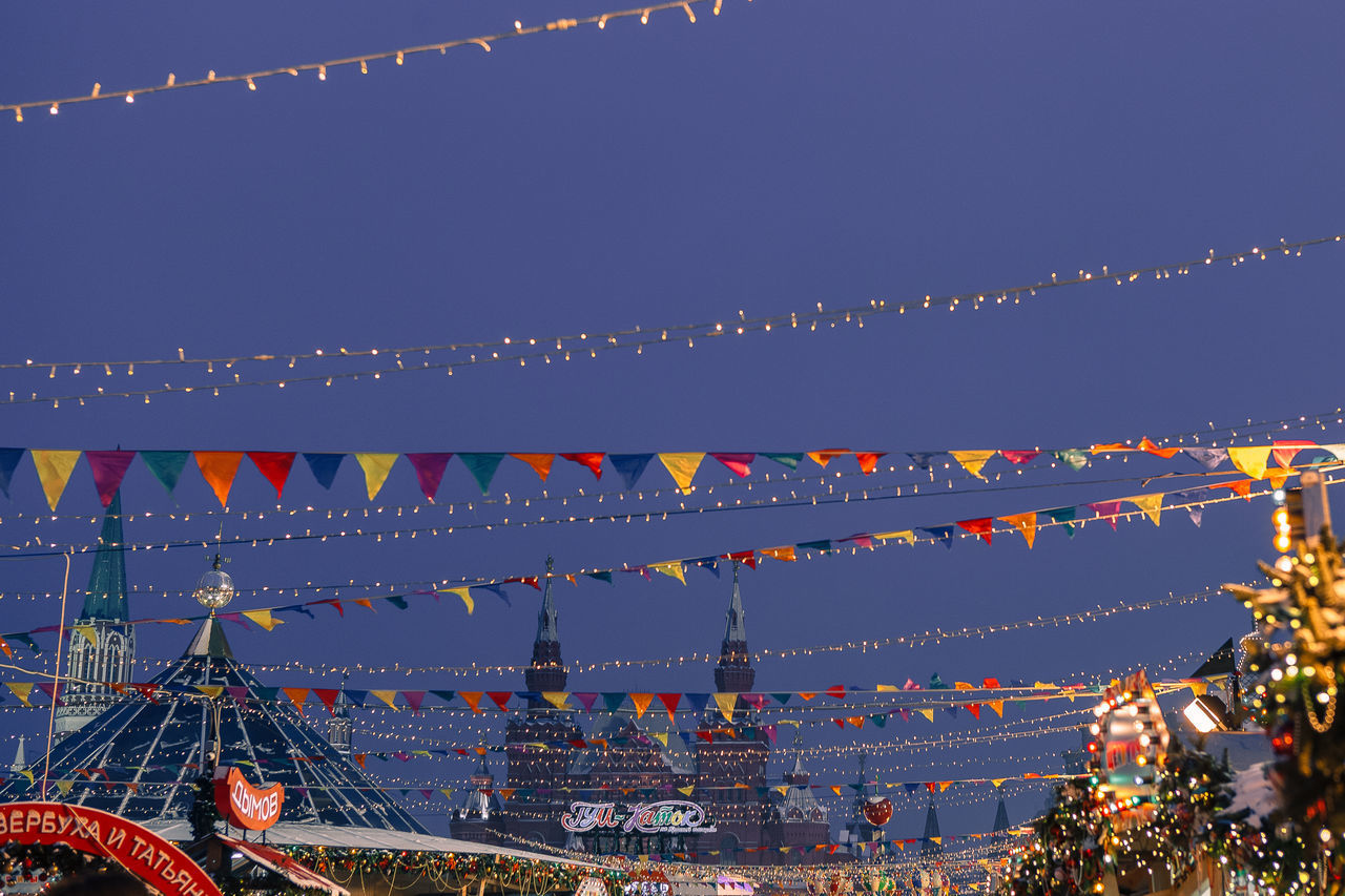 ILLUMINATED LIGHTS AGAINST SKY AT DUSK