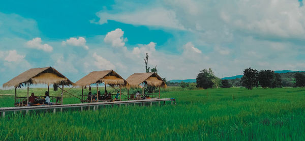 Panoramic view of houses on field against sky