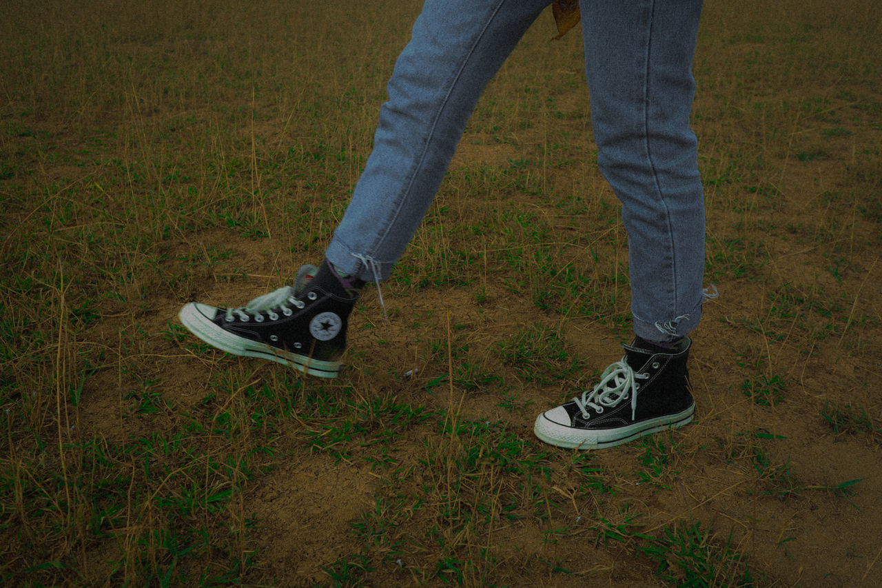 LOW SECTION OF MAN STANDING ON GROUND