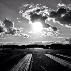 Empty road against cloudy sky