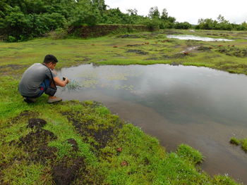 Reflection of man in lake