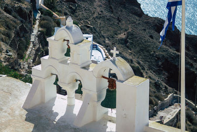 High angle view of cross amidst buildings against mountains