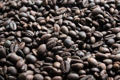 Close-up of roasted coffee beans on table