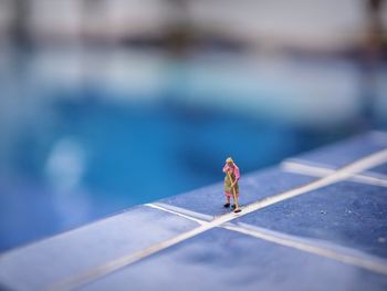 Close-up of small figurine on tiled floor