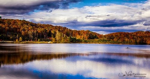 Scenic view of lake against cloudy sky