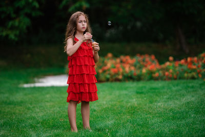 Full length of woman standing on field