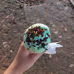 Cropped image of person holding ice cream on street