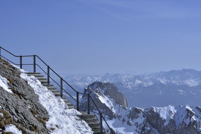 Scenic view of snowcapped mountains against clear blue sky