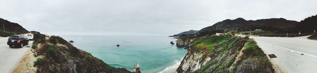 sea, beach, sky, water, panoramic, transportation, horizon over water, scenics, road, mountain, beauty in nature, shore, tranquil scene, nature, incidental people, tranquility, palm tree, coastline, car, sand