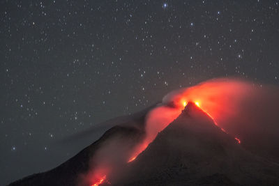 Scenic view of illuminated mountain against sky at night