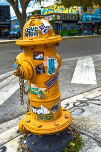 Yellow fire hydrant on road in city