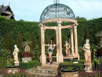 Statue of woman in formal garden