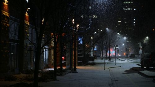 Illuminated city street at night