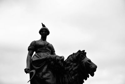 Low angle view of statue against sky