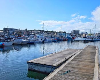 Boats moored at harbor in city