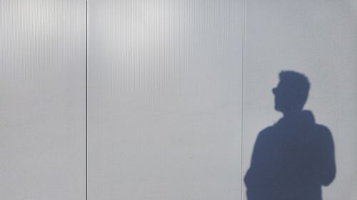 Shadow of man walking on floor