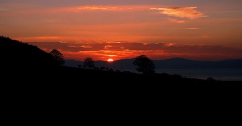 Silhouette of mountain against dramatic sky