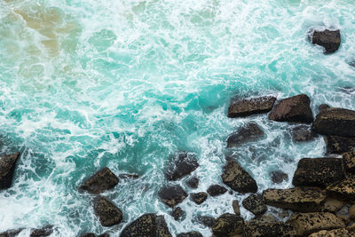 High angle view of rocks in sea