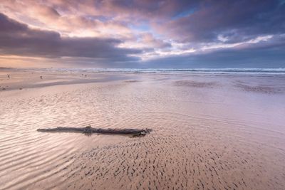 Scenic view of beach against sky during sunset