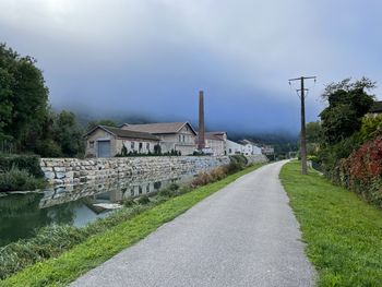 Old factory on canal under foggy sky