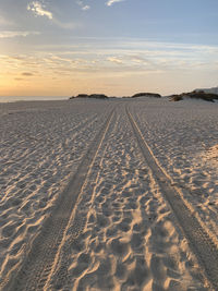 Scenic view of beach against sky during sunset