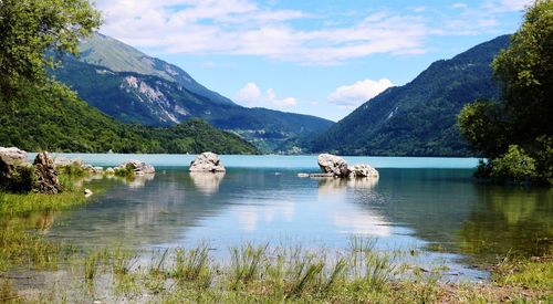 Scenic view of lake and mountains against sky