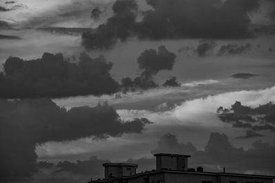 Silhouette buildings against sky at dusk