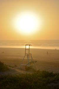 Scenic view of beach against sky during sunset