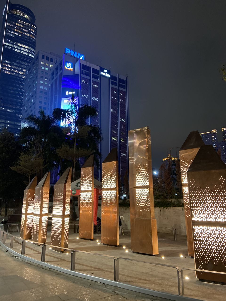 ILLUMINATED BUILDINGS AGAINST SKY