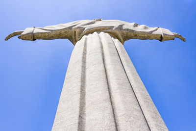 Low angle view of statue against blue sky