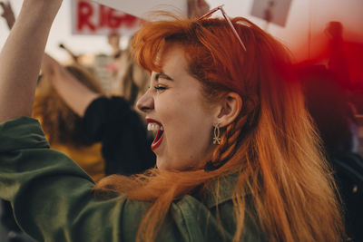 Close-up of young woman shouting while protesting for rights