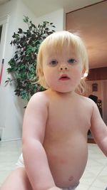 Portrait of shirtless baby boy at home