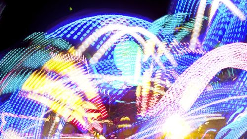 Low angle view of illuminated lights at night