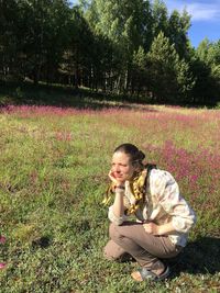 Young woman sitting on field