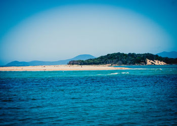 Scenic view of sea against blue sky