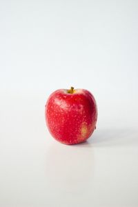 Close-up of red chili peppers on white background