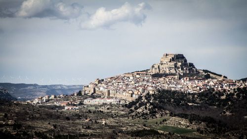 Buildings against cloudy sky